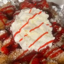 Funnel cake with strawberries and cream